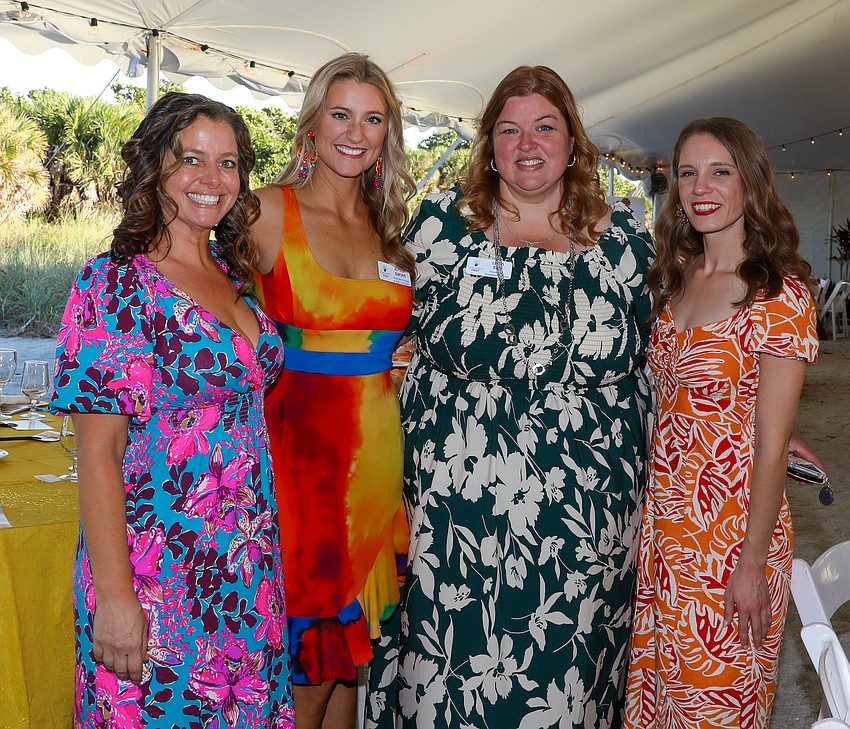Karen Pharo, Alyssa Simons, Linda Bair and Evan Ackerman of Children First welcome guests as they enter Rockin' Lobster.