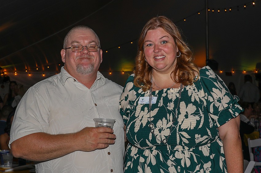 Paul Cox and Linda Bair are having a wonderful time together enjoying the nighttime beach air.