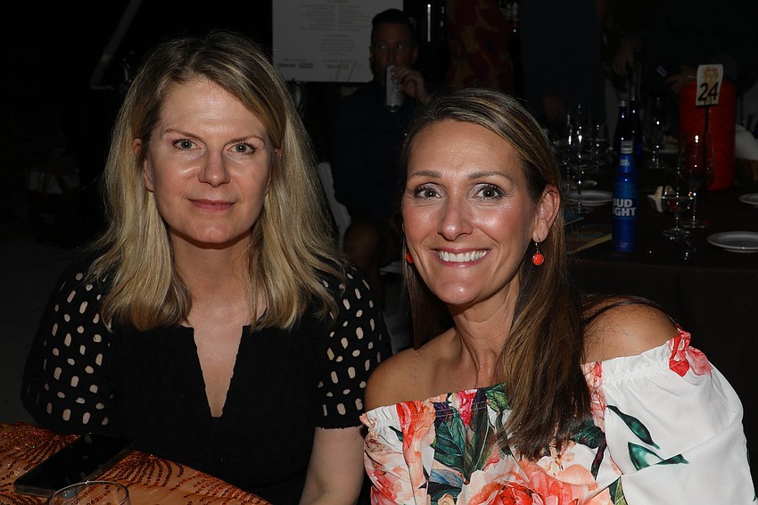 Kate Reed and Kristie Skoglund are all smiles at the dinner table while waiting for the Maine course of lobster.
