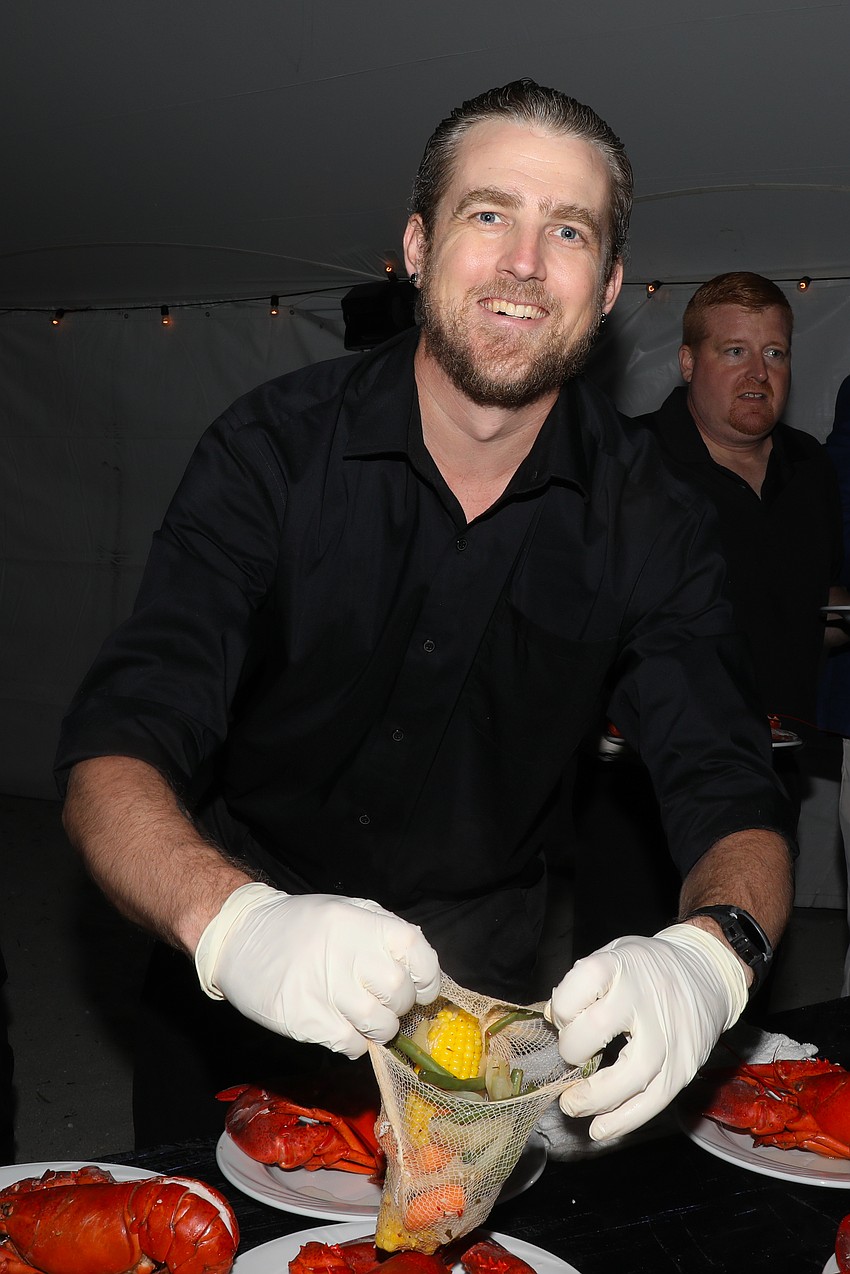 Seth Oesterling puts the finishing touches on the lobster dinner plates tonight.