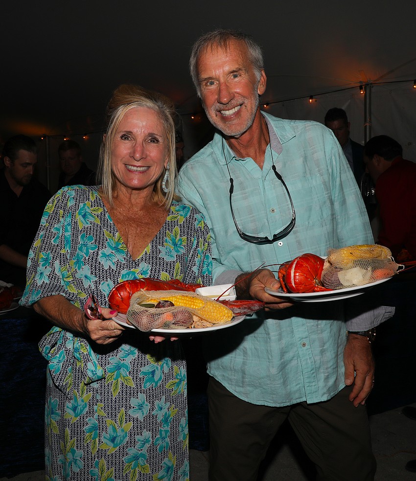Stephania Feltz and Rod Herschberger on the way to their dinner table with fresh lobsters.