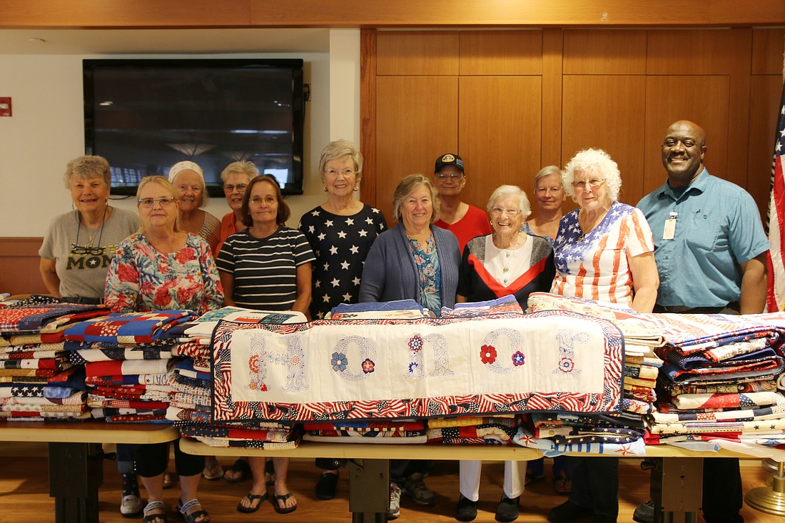 The Quilters by the Sea and John Francis, Emery L. Bennett Veterans’ Nursing Home activities aide. Photo by Jarleene Almenas