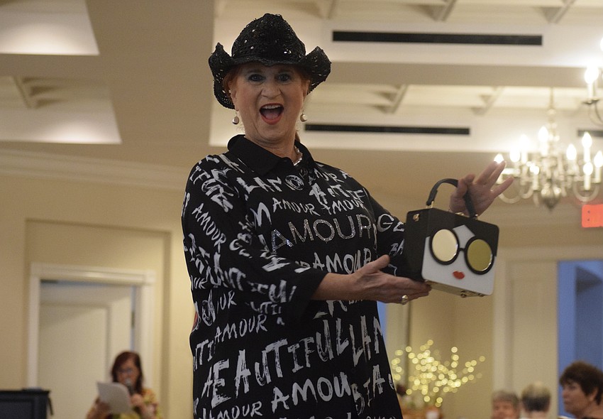 Nancy Chavenson dances down the runway, twirling around to show her outfit and showcase her purse.