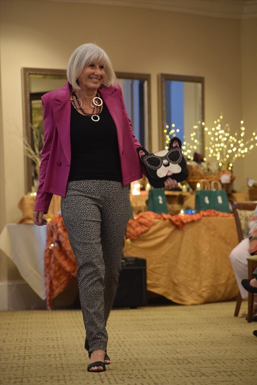 Anne Marie Cole shows off her dog purse as part of her second outfit of the fashion show.