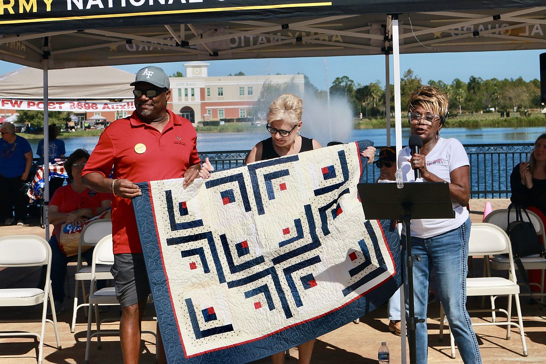 City Council member Cathy Heighter (right) thanks U.S. Air Force veteran Adolphus Evans Jr. (left) for his service with a hand made quilt at the Oct. 29 Remembering Heroes ceremony. Photo by Sierra Williams