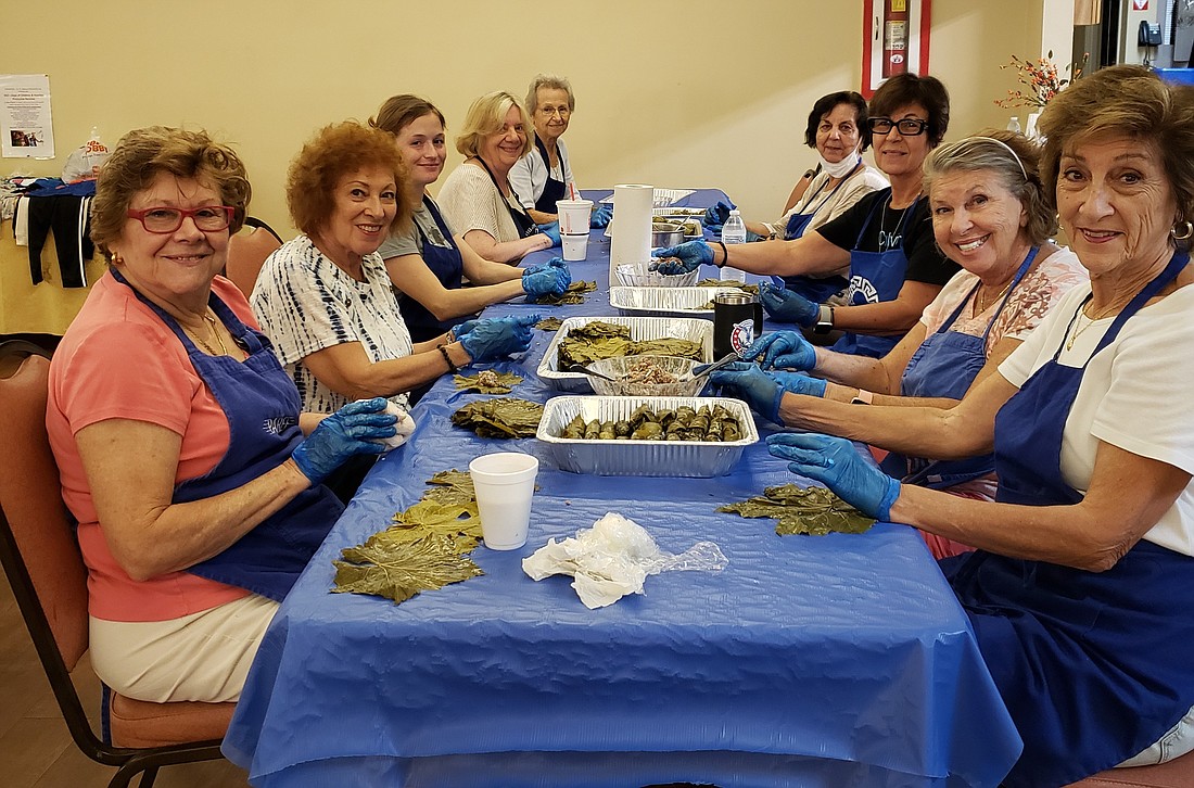 Members of St. Barbara Philoptochos Society gather to make dolmades, which are stuffed grape leaves, for Autumn Fest.