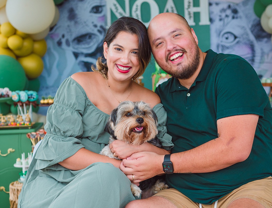 Sam Albuquerque, his wife, Sarah Dornas Albuquerque, and their Yorkshire terrier named Skulí, pose for a photo at their son, Noah’s, baby shower in Apopka.