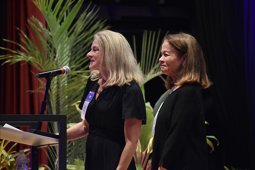 Impact100 SRQ founding president Jane Watt and community investment review committee director Maria Mandler introduce a series of presenters.
