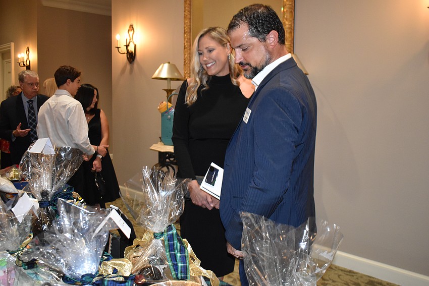 Melissa McNally and her husband, Lakewood Ranch Community Fund board member Keith Pandeloglou, check out silent auction items.