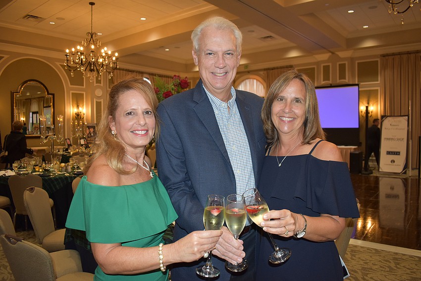 River Club's Karla Wagner, and Mark and Karen Arnold enjoy a champagne toast as the Soirée at the Ranch began to heat up.