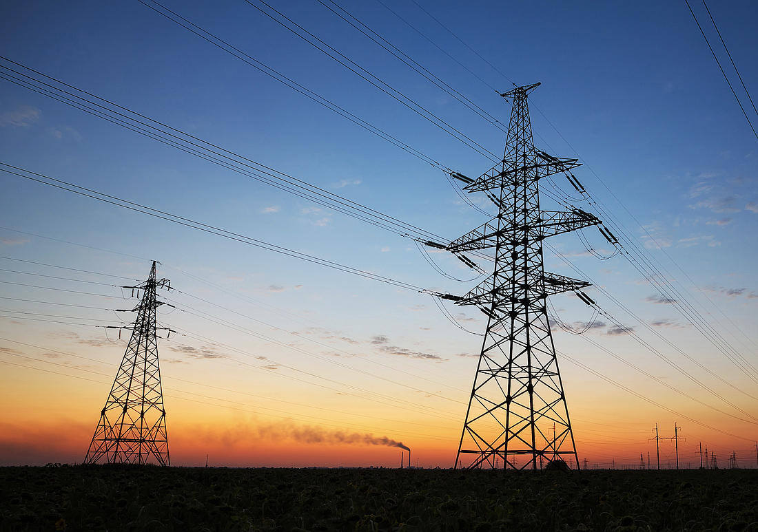Electricity pylons and high-voltage power lines. Photo from Adobe Stock
