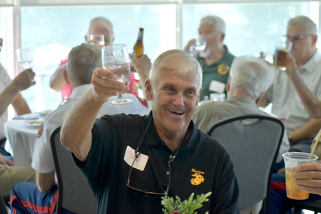Gary Michel participates in a toast.