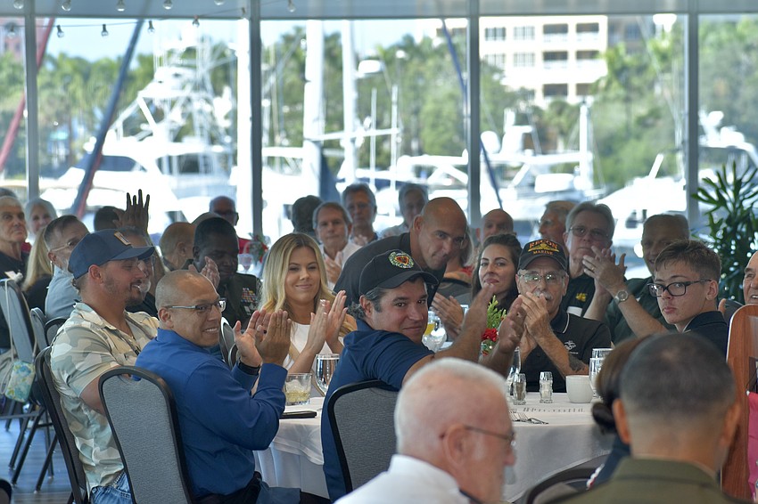 Attendees applaud an announcement by Tom Smith.