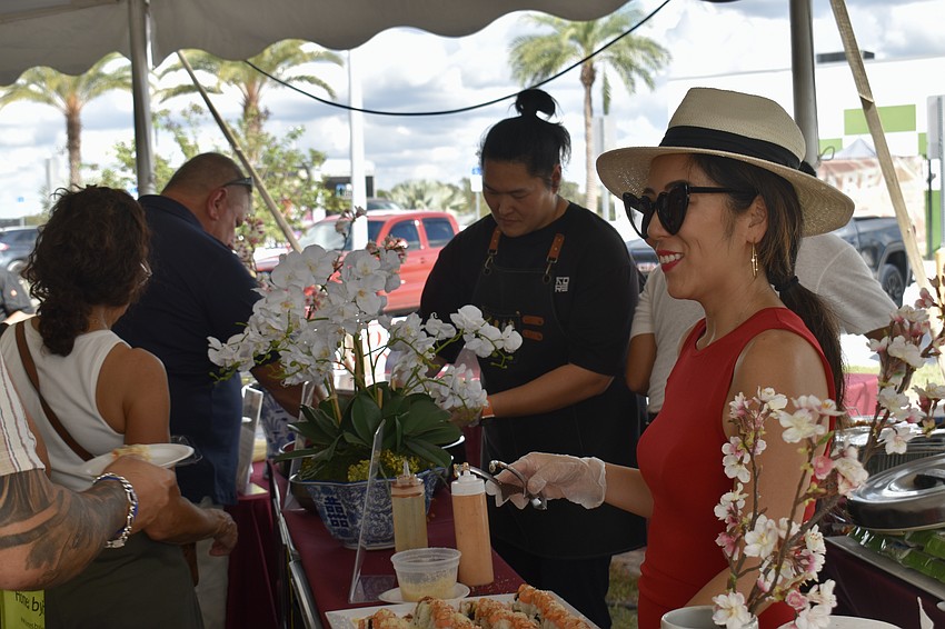 Owner of JPAN Sushi & Grill and Kore Steakhouse, Clarice Dokko, serves guests sushi rolls.