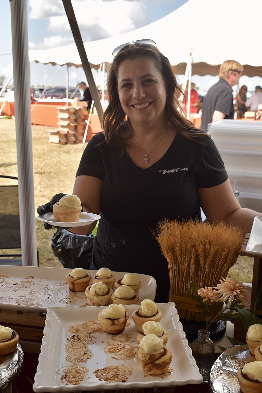Co-owner of the Breakfast Company, Lisa Pappas, serves cinnamon buns.