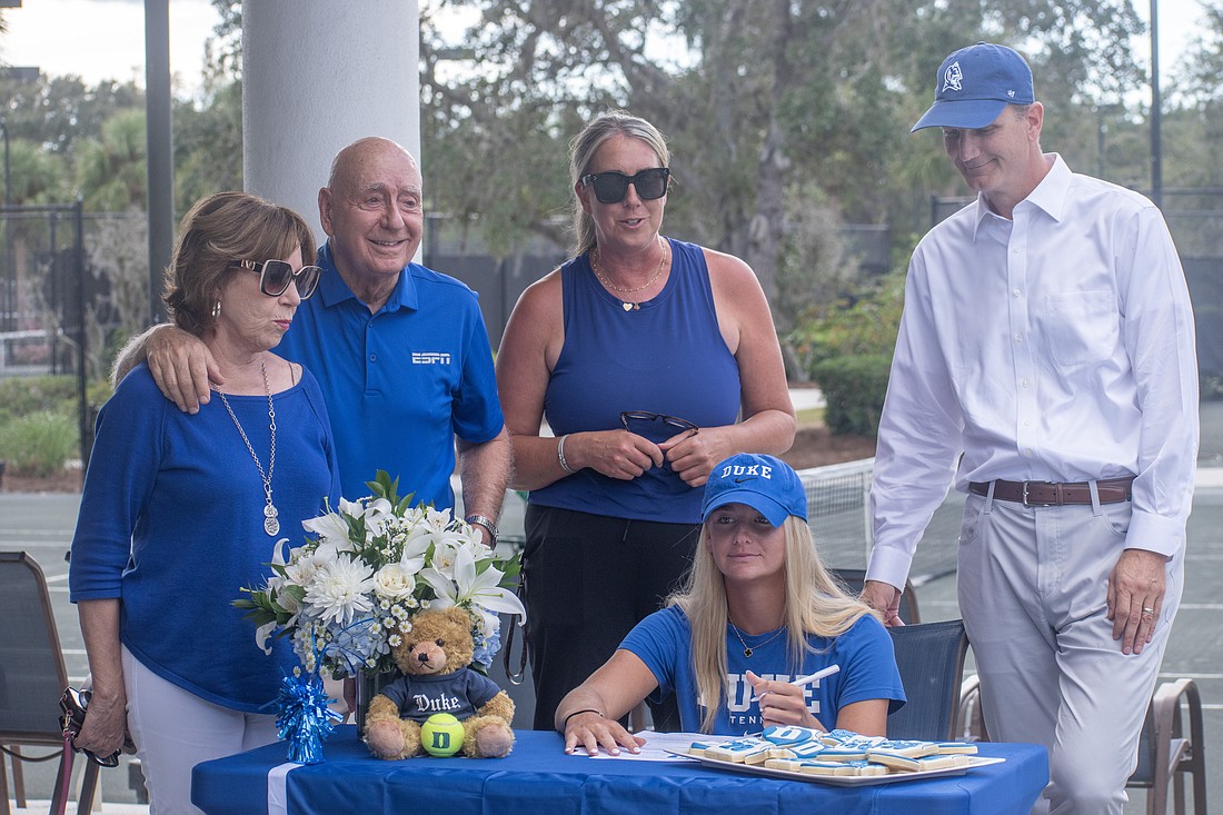 Lorraine Vitale, Dick Vitale, Sherri Vitale Krug and Thomas Krug surround Ava Krug as she signs with Duke University for women's tennis.