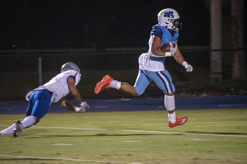 ODA sophomore running back Allen Clark evades a tackle attempt from LPCA senior Jayden Bonhomme (1) on the way to the end zone.