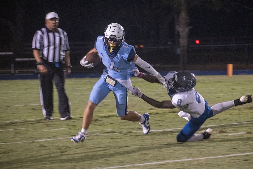 ODA senior Jack Meyers (4) stiff arms LPCA senior Cohagen Mobley (8) on a first-quarter run. Meyers would later add a 13-yard touchdown run.