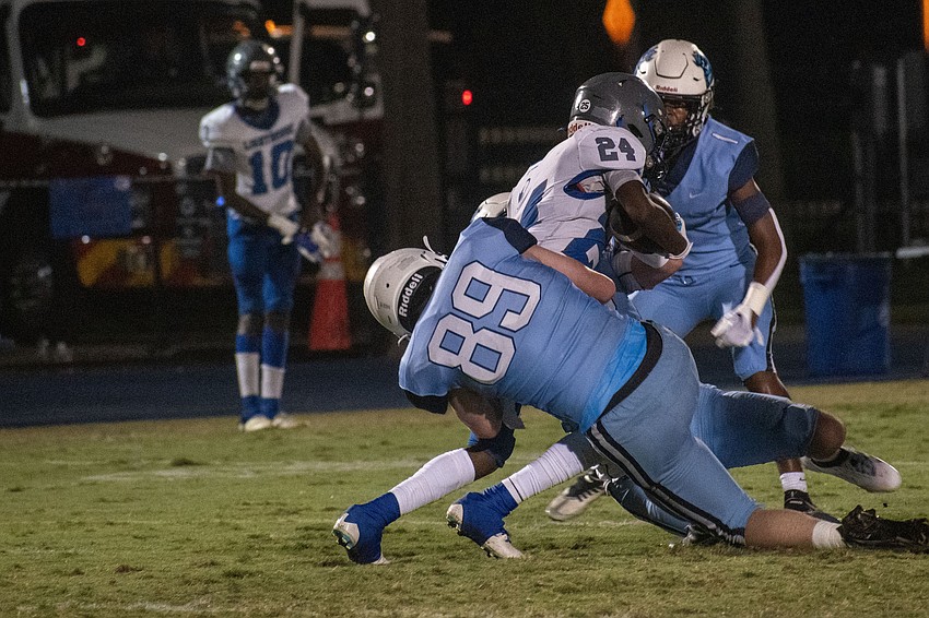 ODA senior Robert Crisci (89) tackles LPCA freshman Jayden Crenshaw (24) in the backfield for a loss.