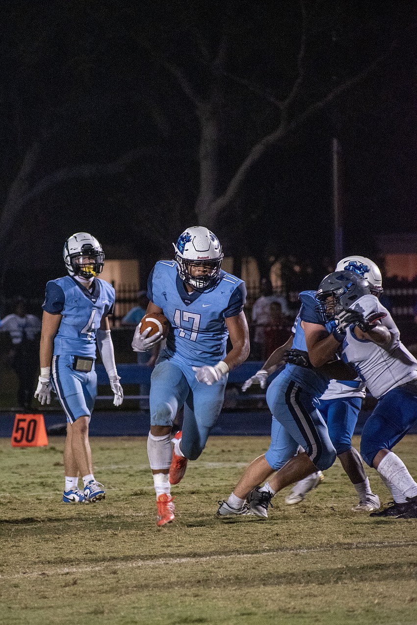 ODA sophomore running back Allen Clark (17) breaks through the LPCA defense for a big gain. Clark had three touchdown runs against the Stingrays.