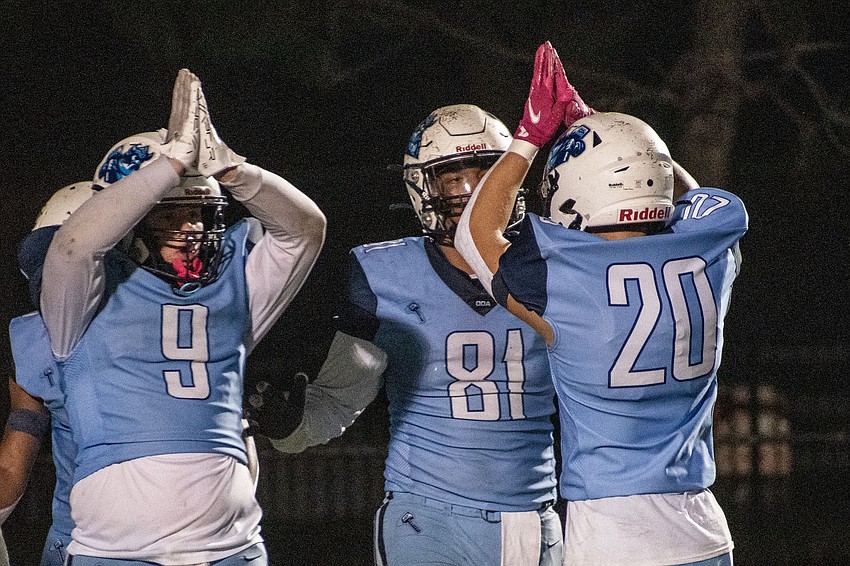 ODA linebacker Heath DeRusso (8), defensive lineman Thomas Perez (81) and safety Jack Taraska (20) come together after the ODA defense forced LPCA into a safety, as signaled by DeRusso and Taraska.