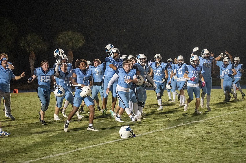 The Thunder football team celebrates as students rush the field after ODA's SSAA Class 4A championship win.