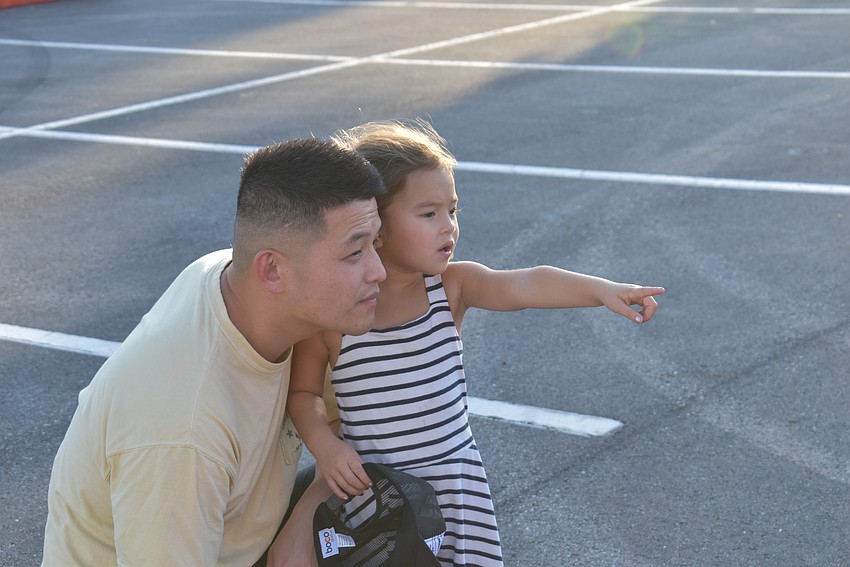 Sarasota's Hong Chen and his daughter, 4-year-old Stella, check out Elsa of 
