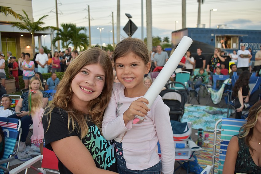 Jillian Glass, 13, and Kristen Glass, 6, have a great time before the Santa's Grand Arrival Parade. What do they like the most? 