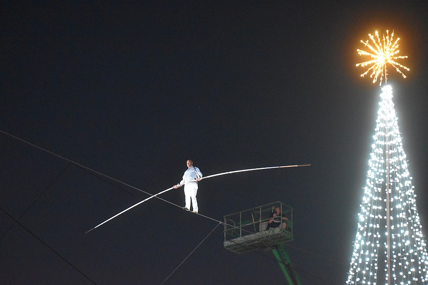 Nik Wallenda begins his walk across Cattlemen Road to kick off the Santa's Grand Arrival Parade.