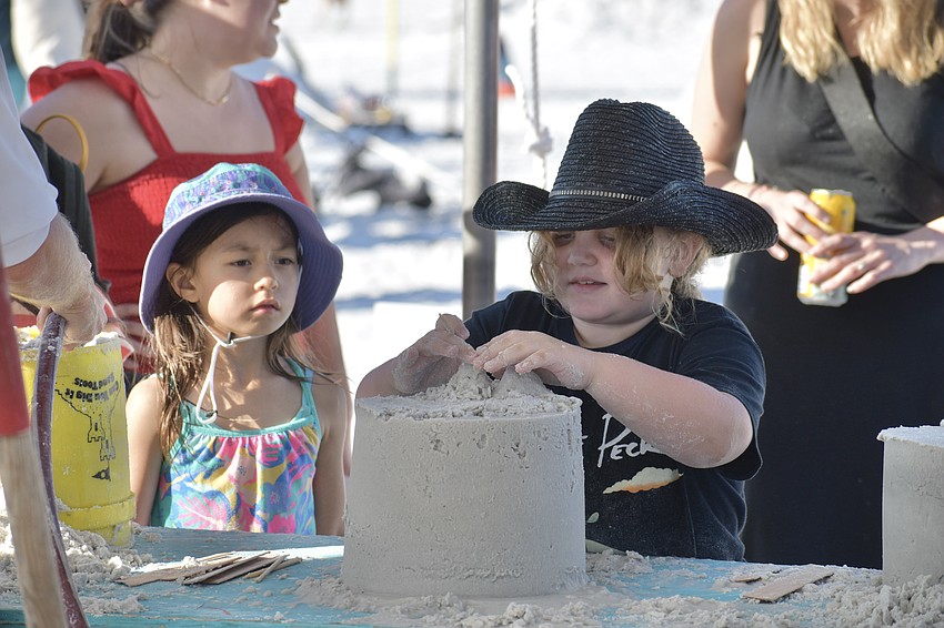 Lucia Molnar, 6, watches as Fable Enneking-Barnett, 8, makes a sculpture.
