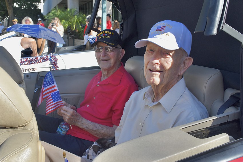World War II veteran Al Perkowski and Korean War veteran William Taft await the start of the parade.