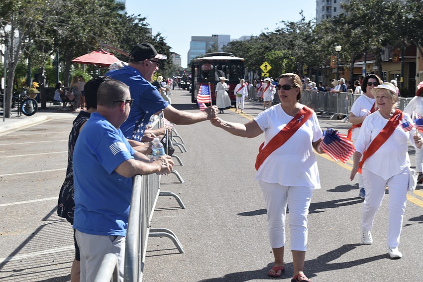 Jim Schultz accepts a flag from Daughters of the American Revolution member Shawna Smith.