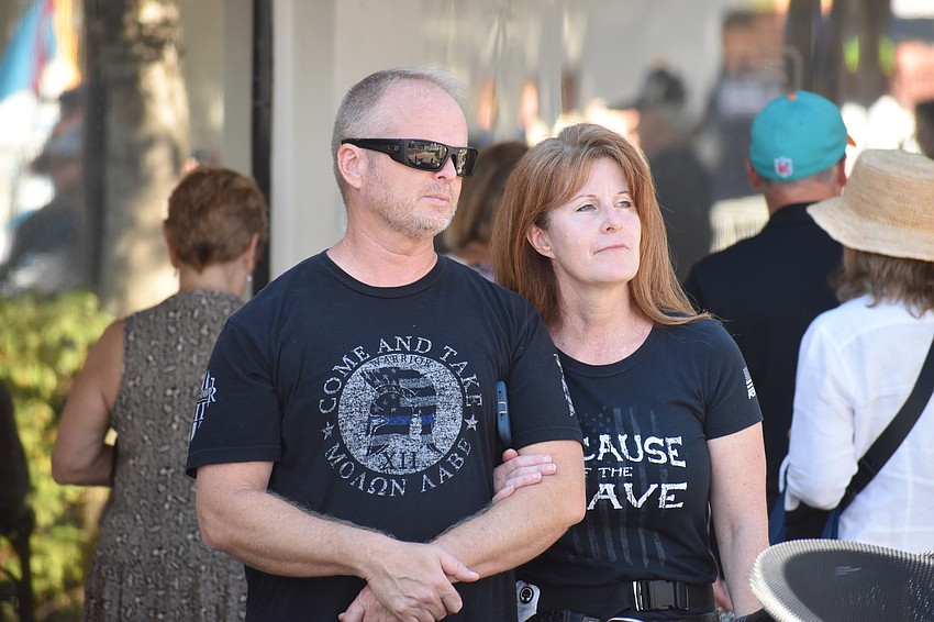 Travis and Susan Huggins watch the parade.