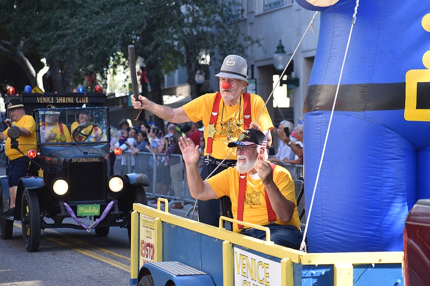 Members of Venice Shrine Club ride on a float with an inflatable clown.