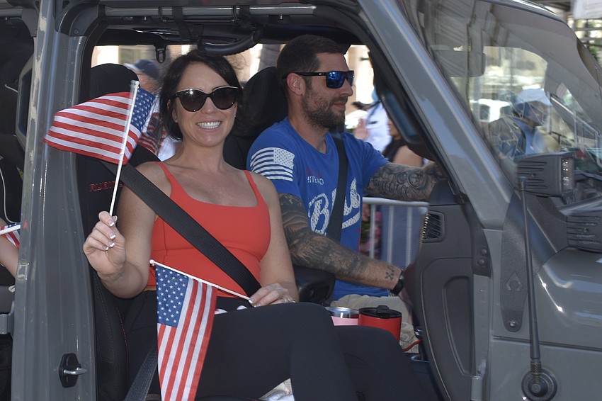 William and Shanna Warner drive by in a jeep.
