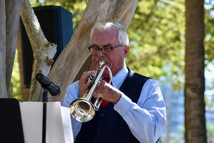 Danny Bilyeu plays taps in the ceremony at J.D. Hamel Park.