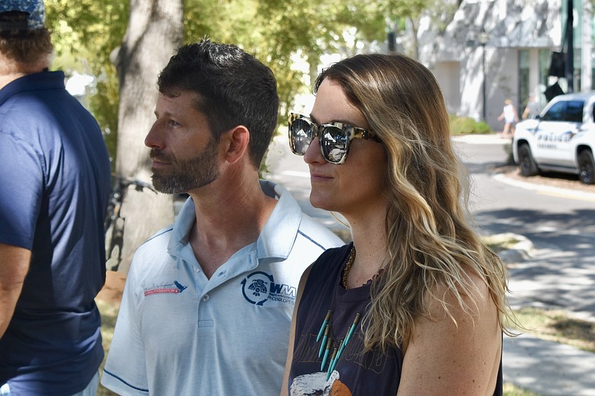 Aaron Burkett of the James Lee Burkett Memorial Foundation, and his friend Amanda Waitsman of Semper Fi Steel Built watch the ceremony.