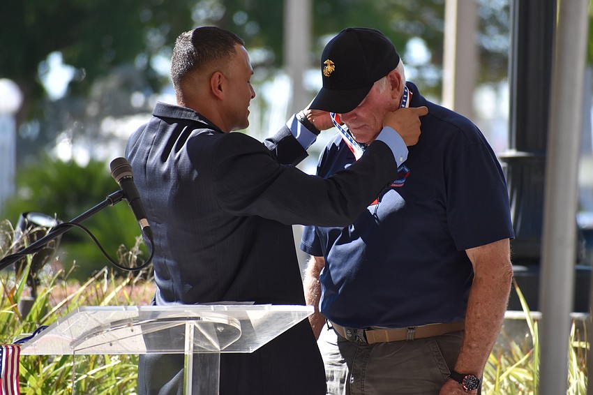 Carlos Moreira,  guest speaker at the event and a U.S. Marine Cops veteran, honors Ted Smith, also a U.S. Marine Cops veteran, with the John H. McLain Veteran of the Year award.