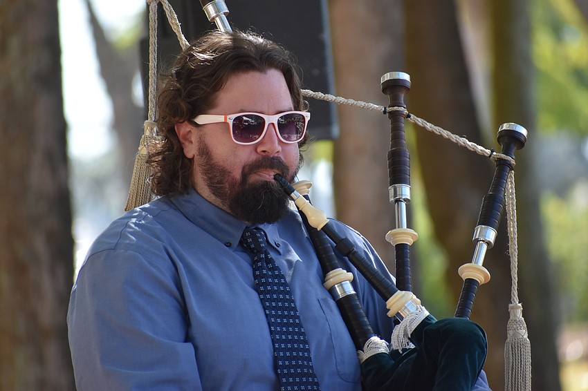 Micah Adams plays bagpipes during the ceremony at J.D. Hamel Park.