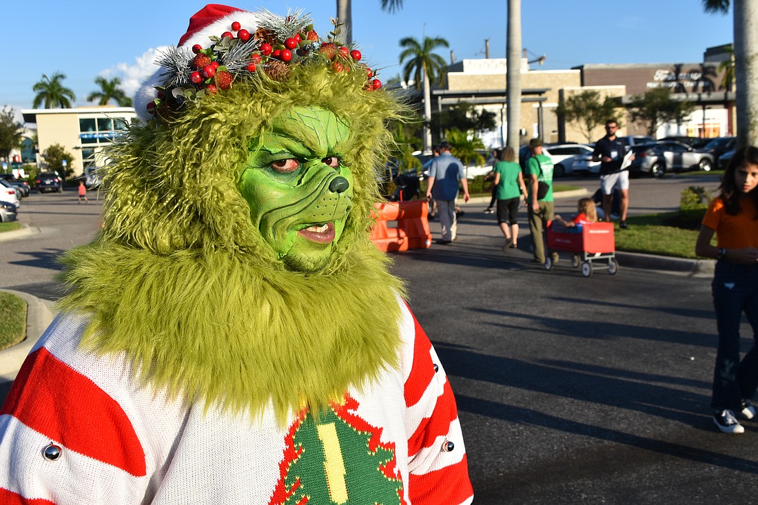 The Grinch, in this case Kingsley Sim, appeared at the Santa's Grand Arrival Parade at UTC. His job, however, was to make people smile.
