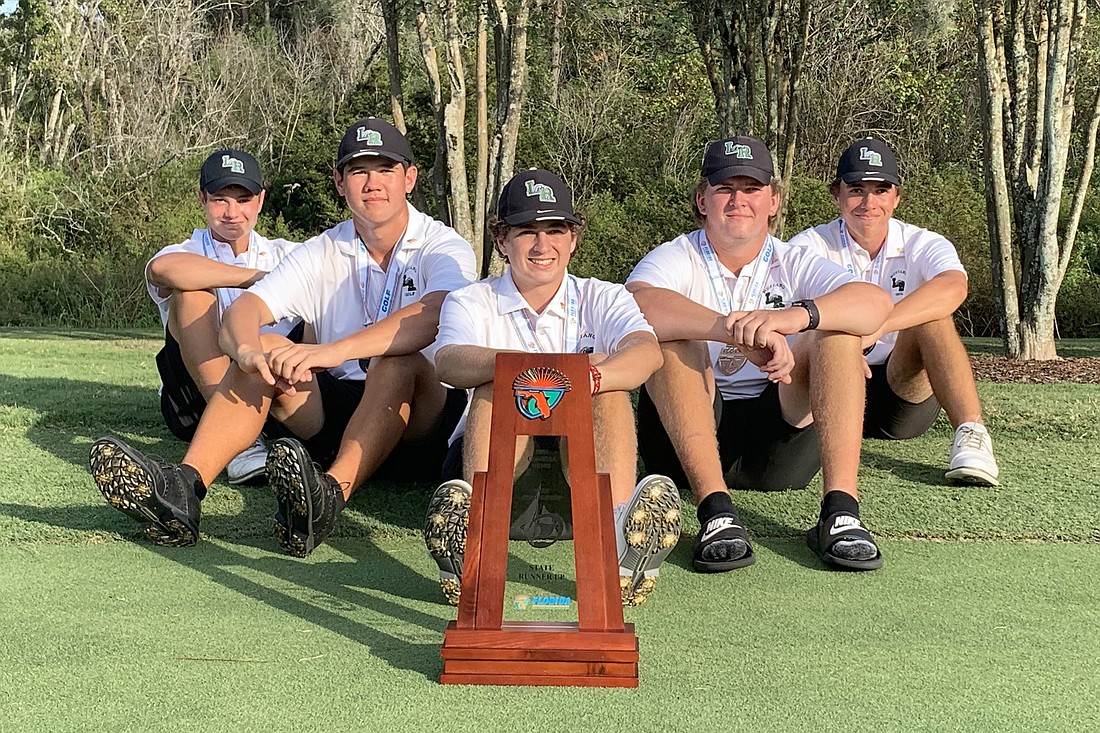 Lakewood Ranch High sophomore Max Colby Bendixen, junior Parker Severs, sophomore Josh Orgen, junior Henry Burbee and junior Luke Wilson sit with the FHSAA Class 3A boys golf runner-up trophy.
