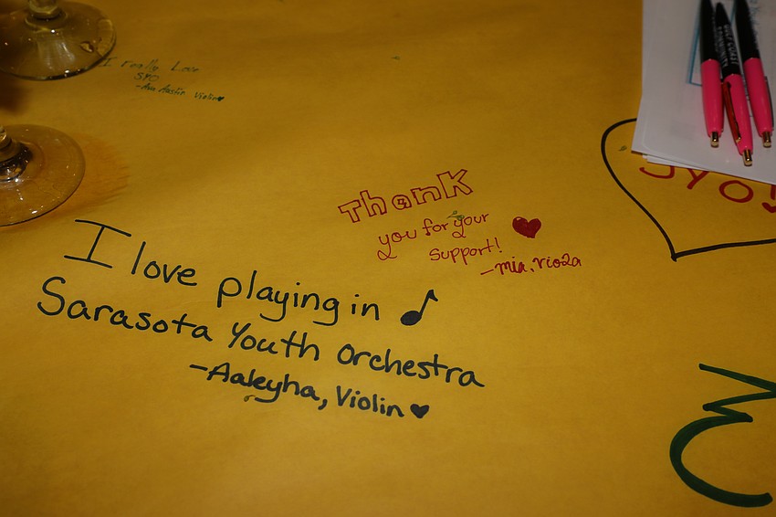 The Sarasota Youth Orchestra members decorated the table-top centerpieces with drawings and messages for the guests.