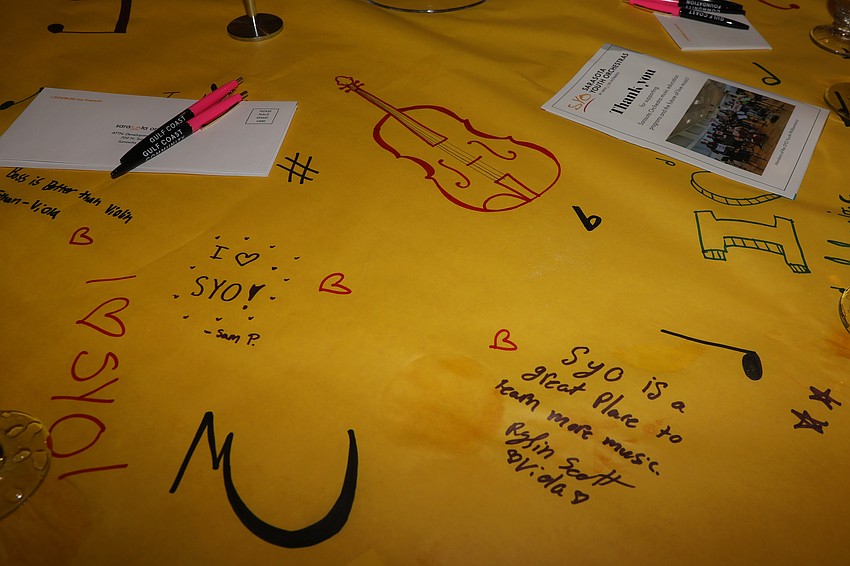 The Sarasota Youth Orchestra members decorated the table-top centerpieces with drawings and messages for the guests.