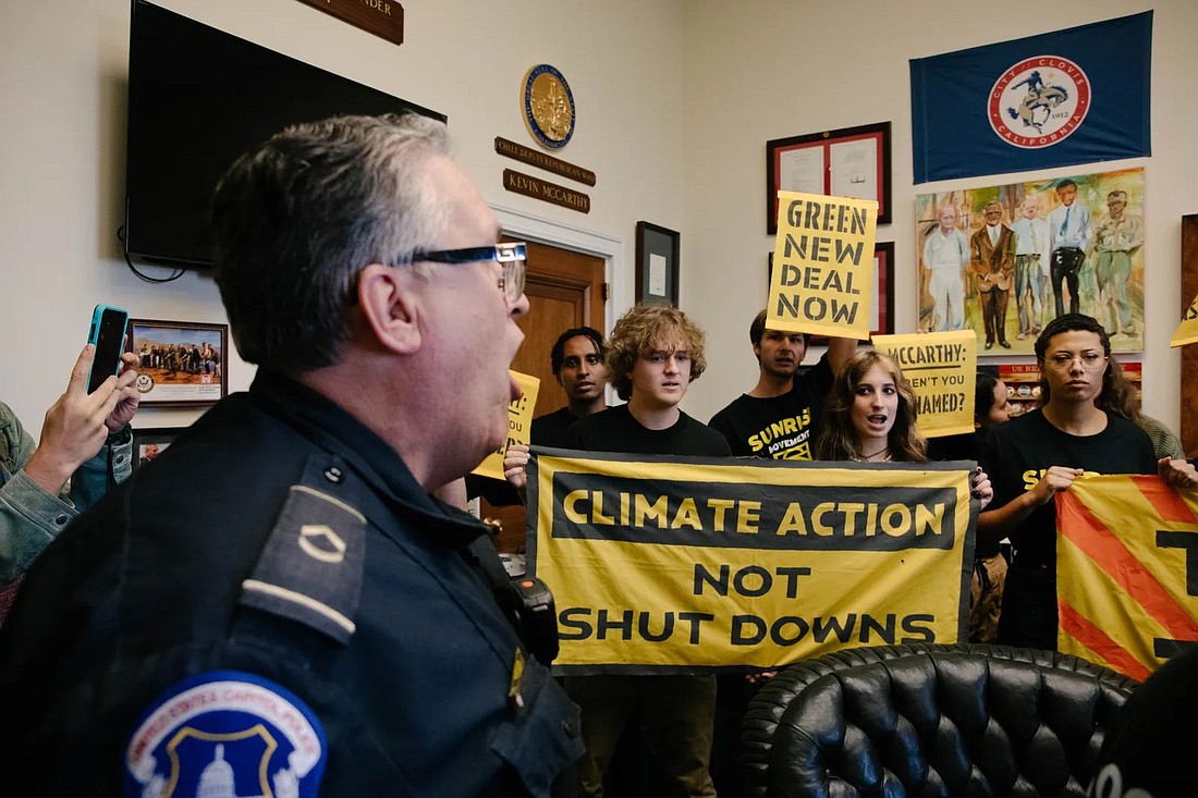 Flagler Palm Coast High School graduate Cameron Driggers, center, protests at former House speaker Kevin McCarthy's office on Sept. 28. Courtesy photo