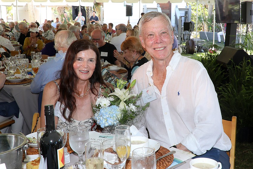 Co-chairs Susan and Tim Flood receive a bouquet of flowers in appreciation for their work.