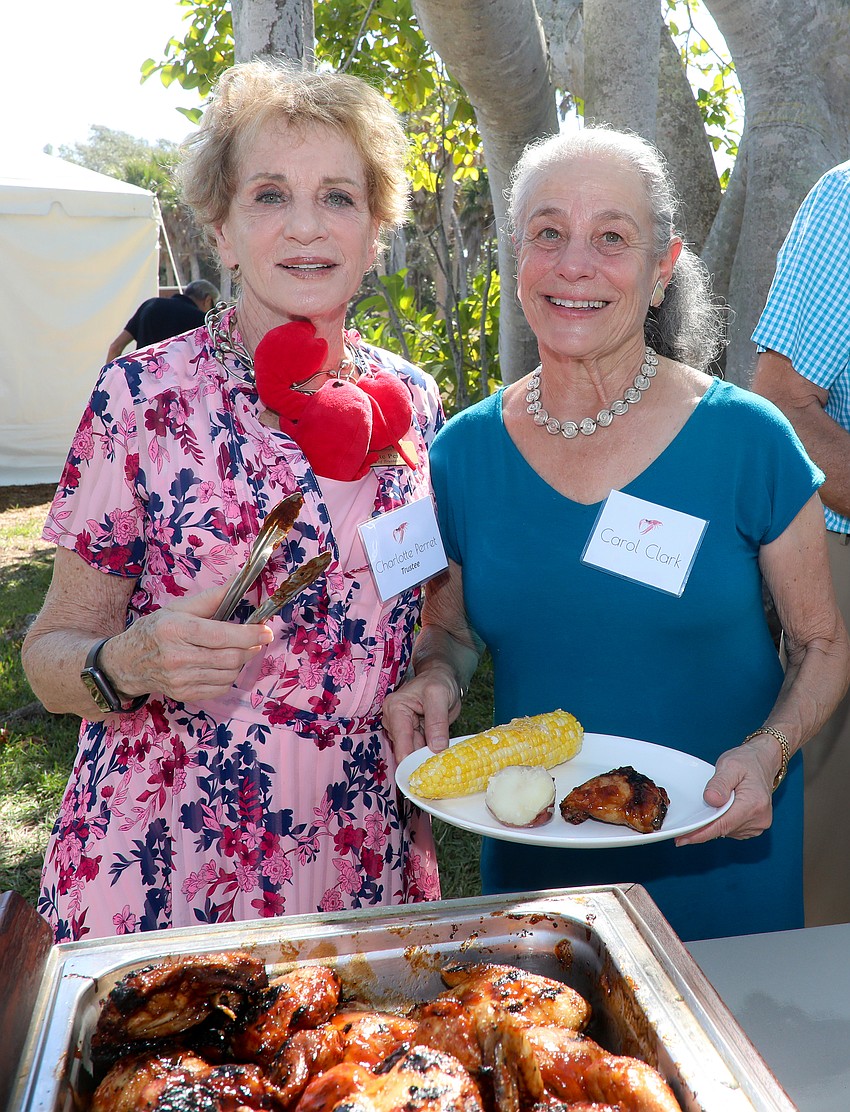 Trustee Charlotte Perrett and friend Carol Clarke get ready for the lobster feast.