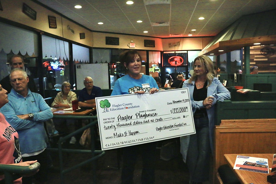 Foundation Executive Director Teresa Rizzo presented a $20,000 check to Flagler Playhouse President Jerri Berry at the Playhouse kick-off fundraising event on Nov. 14. Photo by Sierra Williams