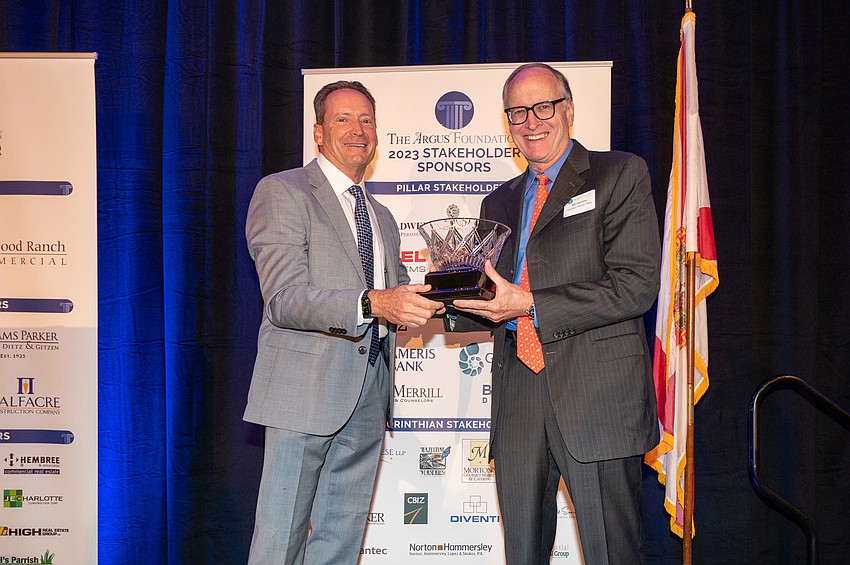 Kirk Boylston and  Bill Harrison accepting a lifetime achievement award for his father, William Harrison.