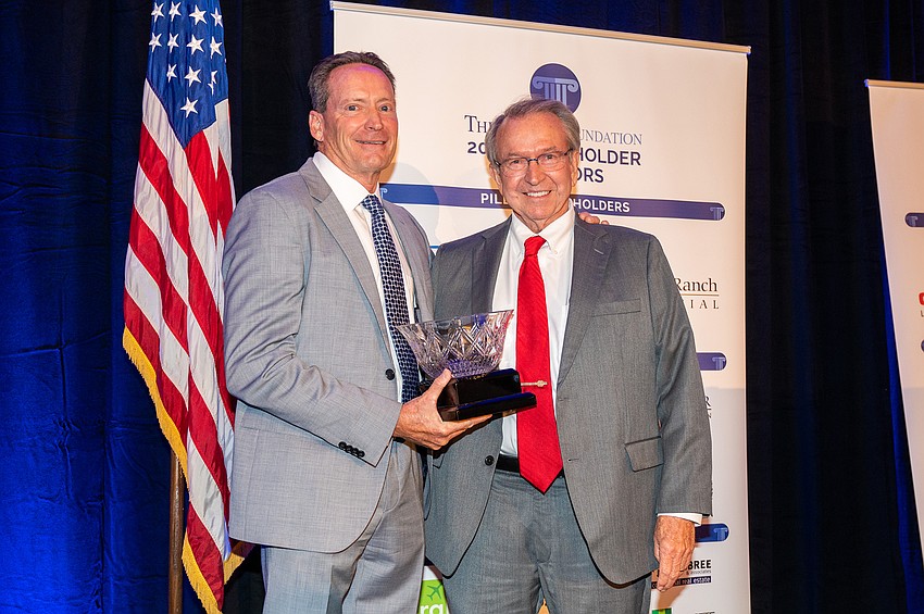 Kirk Boylston and Jon Swift accepting his Argus Lifetime Achievement Award