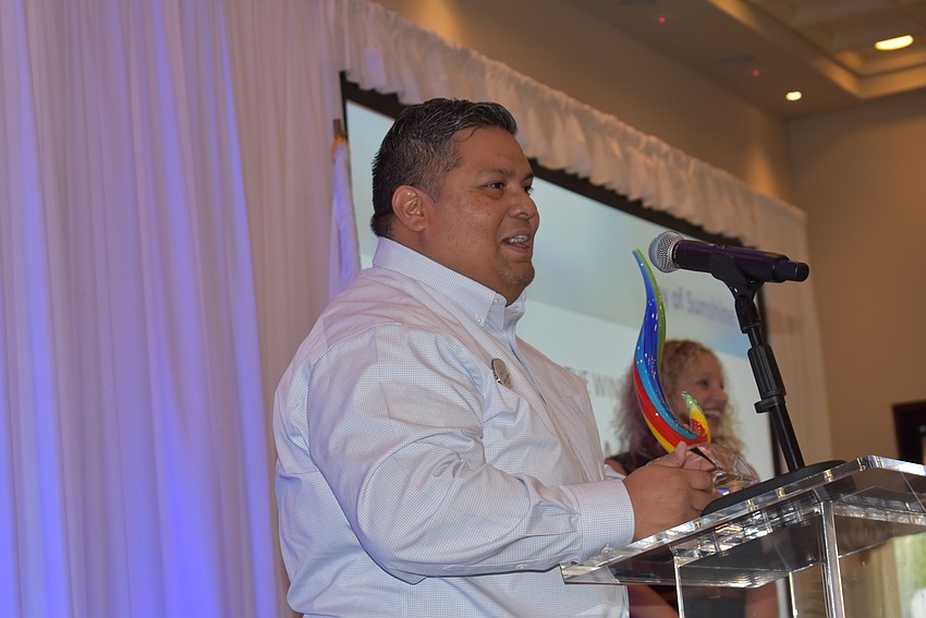 Jorge Augero of Family Legacy Care addresses the crowd after winning the Ray of Sunshine award.